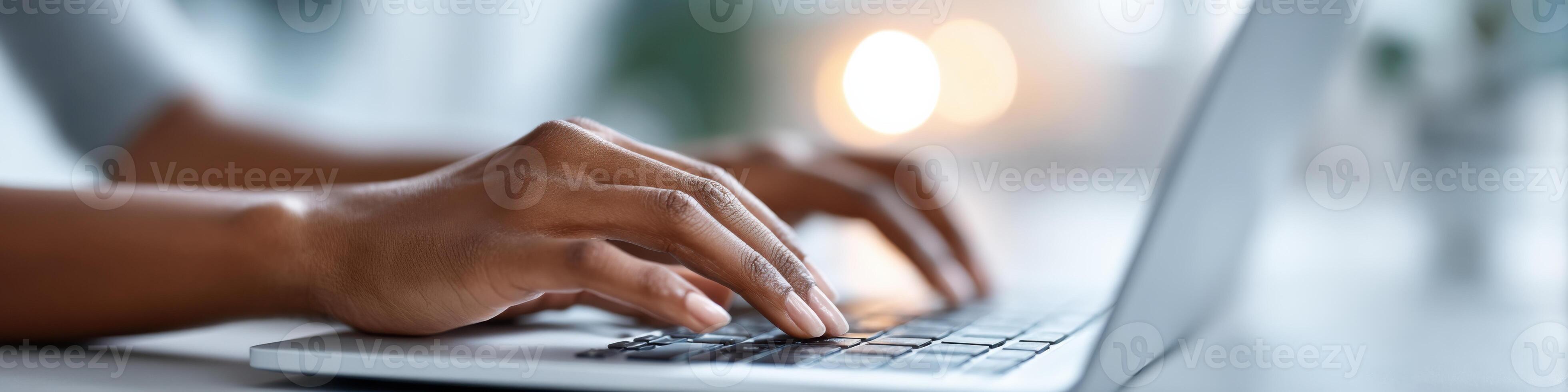 Close-up of hands typing on a laptop while searching for part-time jobs amid study materials photo