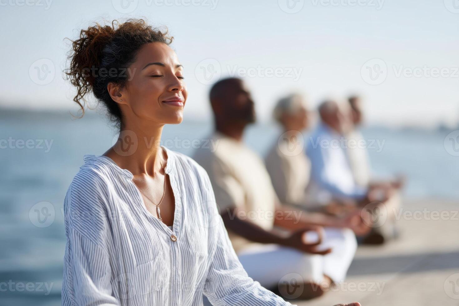 Joyful community practices meditation by a vibrant lake enhancing serenity and mindfulness photo