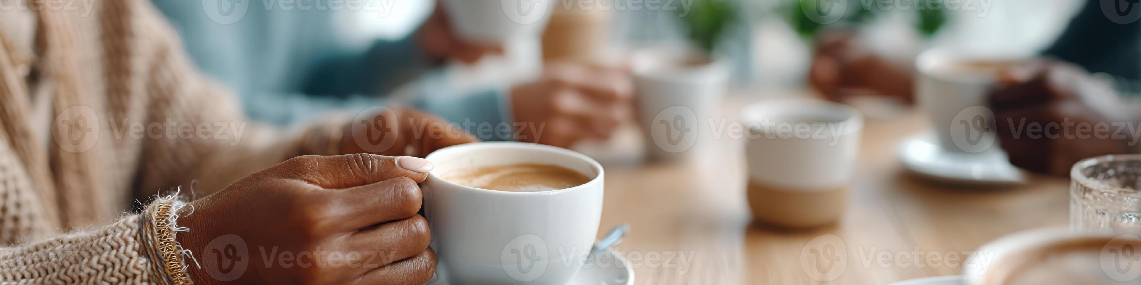 Diverse hands stirring coffee together in a cozy setting fostering connection and conversation photo