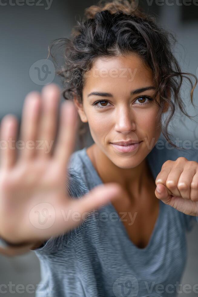 Empowered young woman practicing self-defense techniques in an urban training studio photo