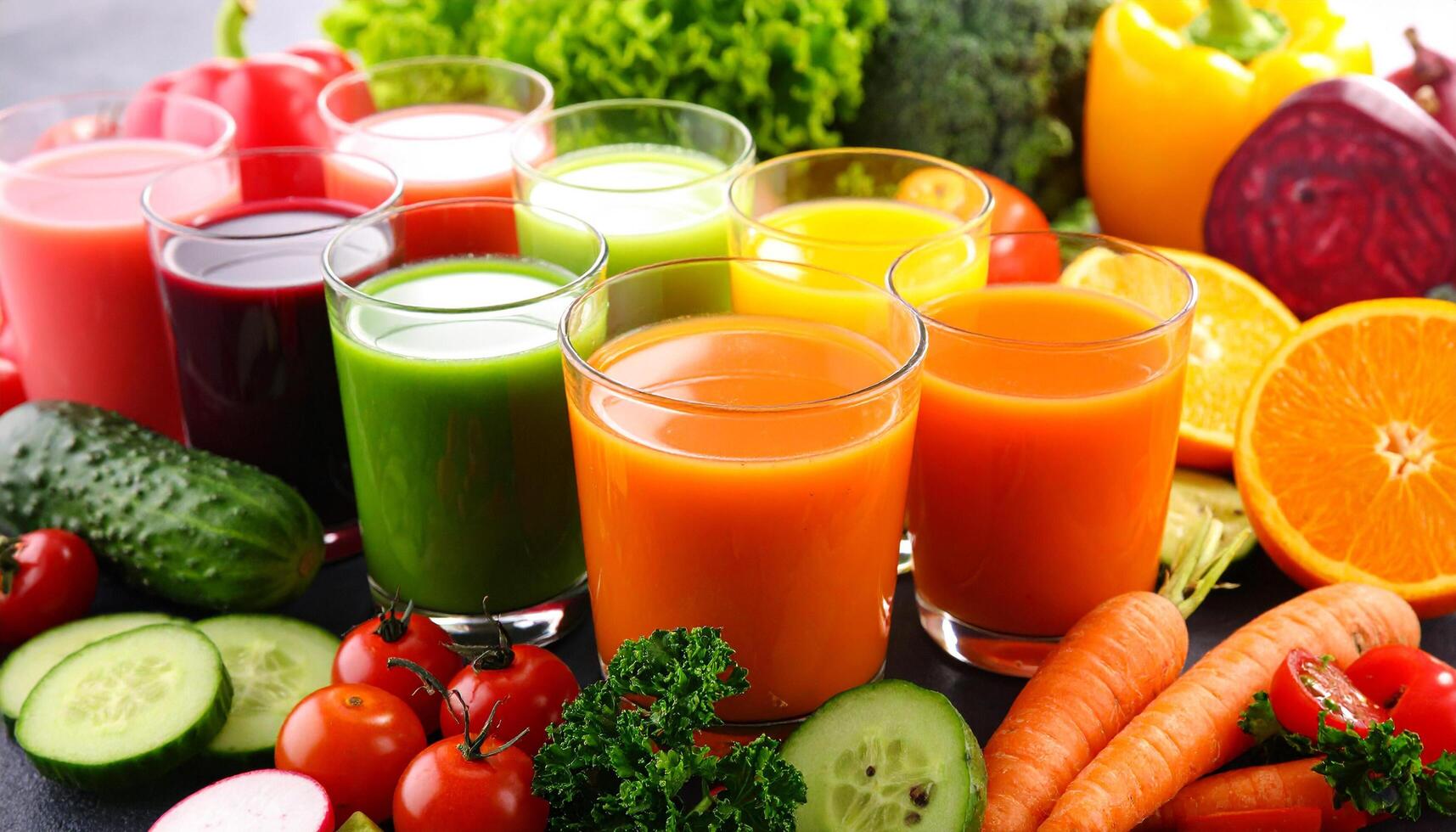 Colorful assortment of freshly squeezed vegetable and fruit juices in glasses, a healthy and vibrant drink collection. photo