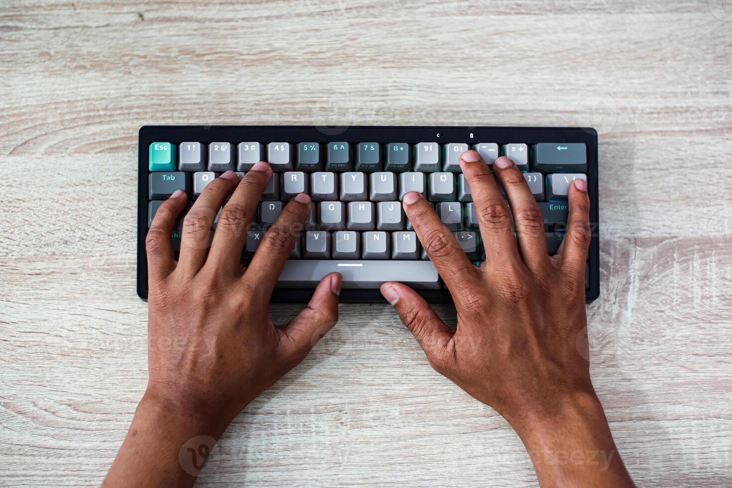 Overhead View of Hands Typing on a Gray and White Keyboard photo
