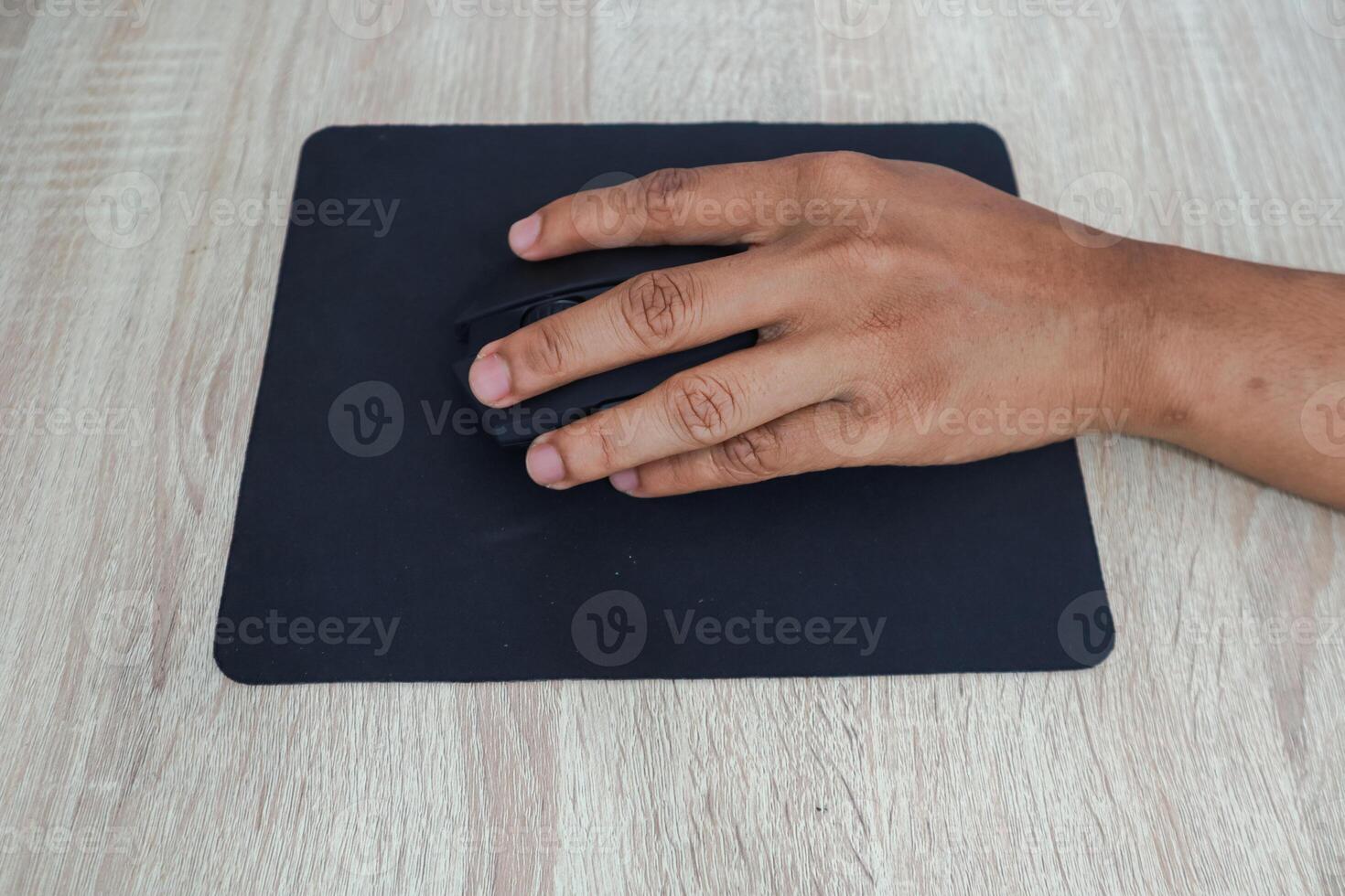 Hand Using Computer Mouse On Wooden Desk photo