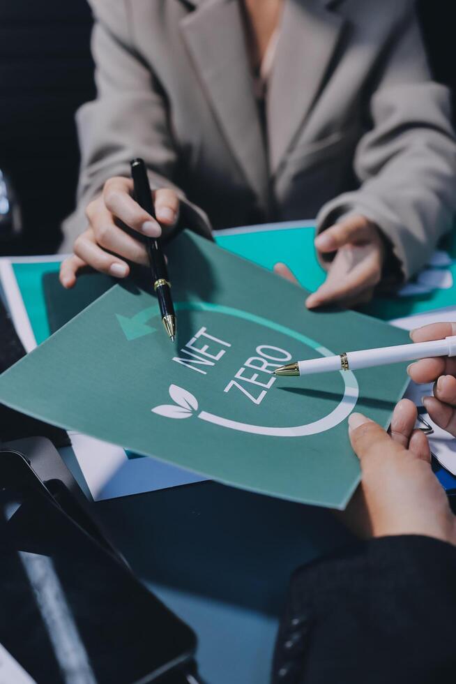 Business people holding a green paper with the word zero on it photo
