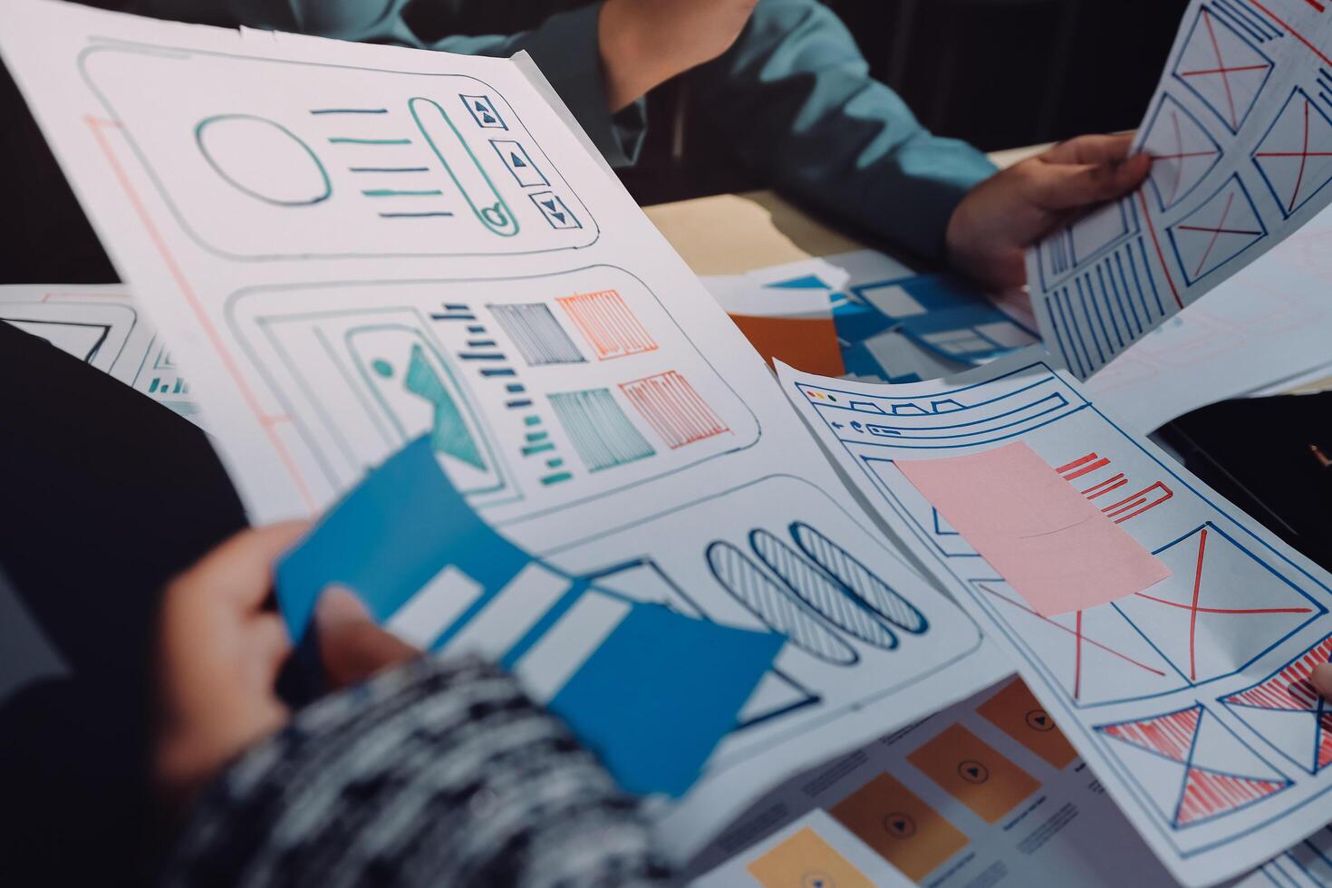 People are holding papers with diagrams on them photo