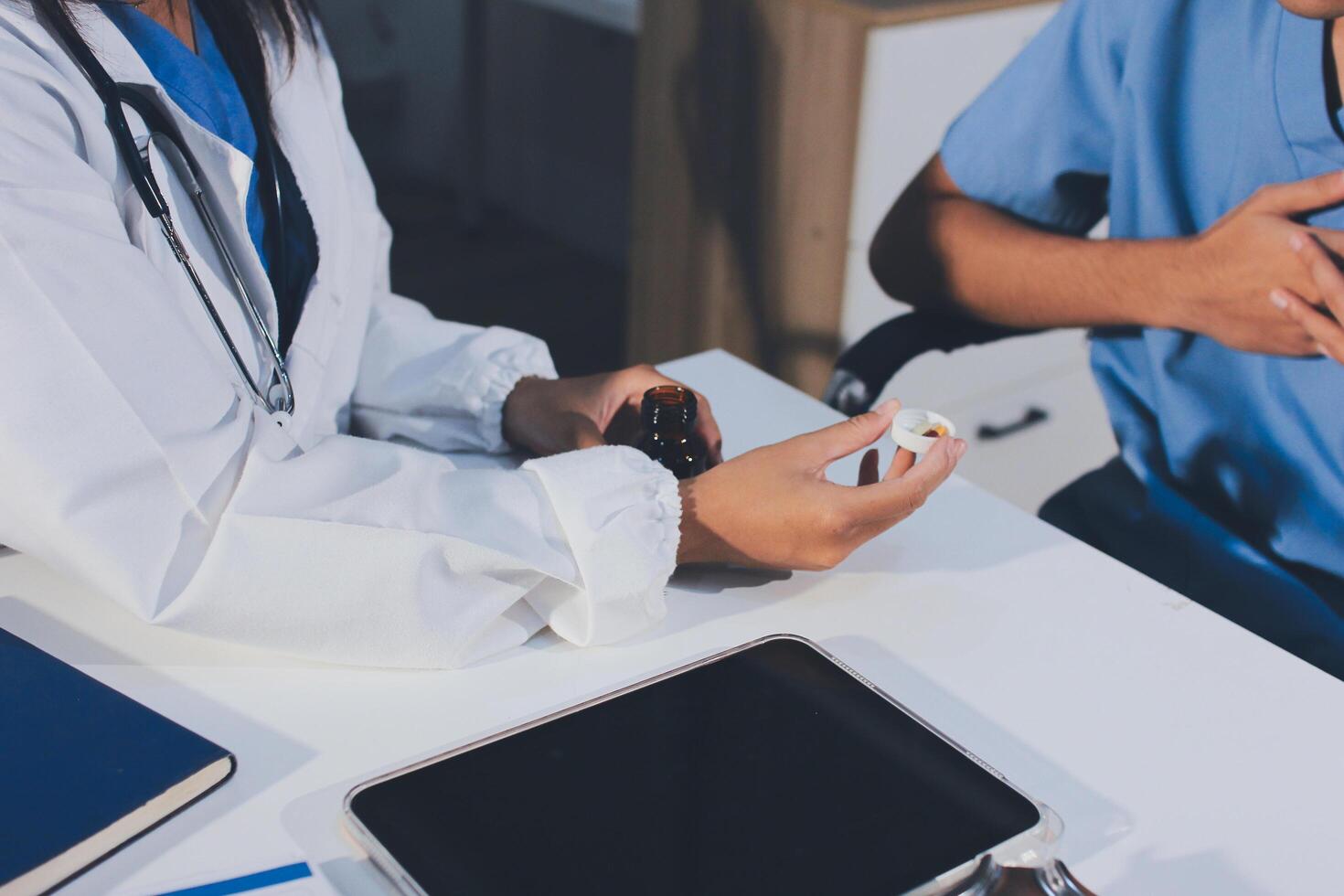 A doctor is holding a pill to a patient's chest photo