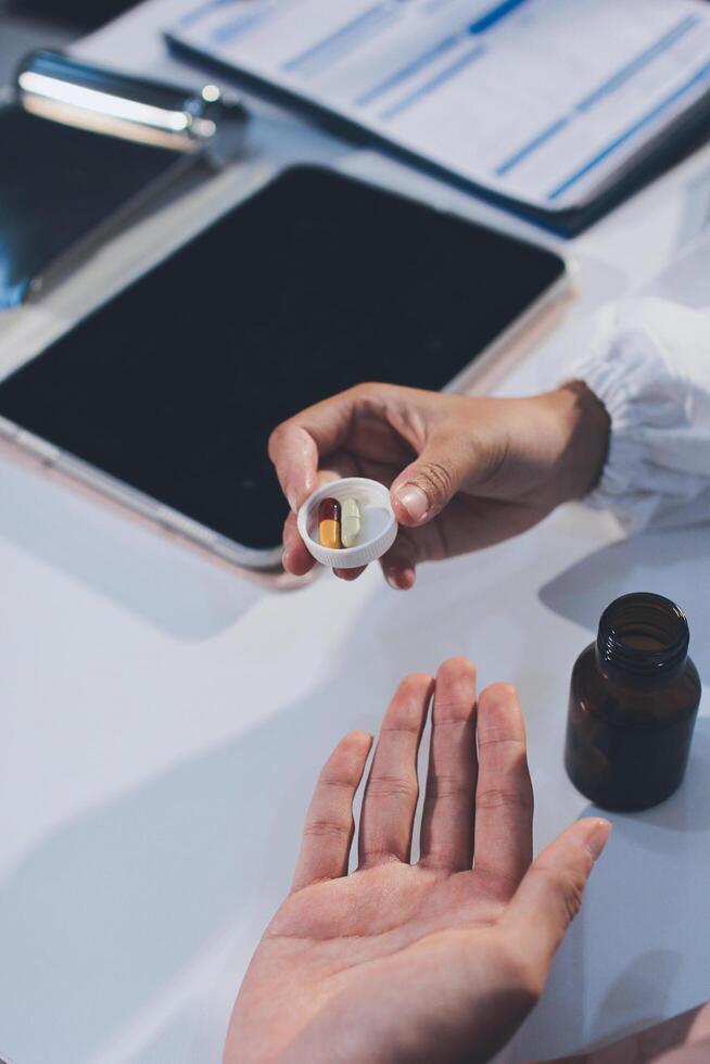 A person holding a pill in their hand photo