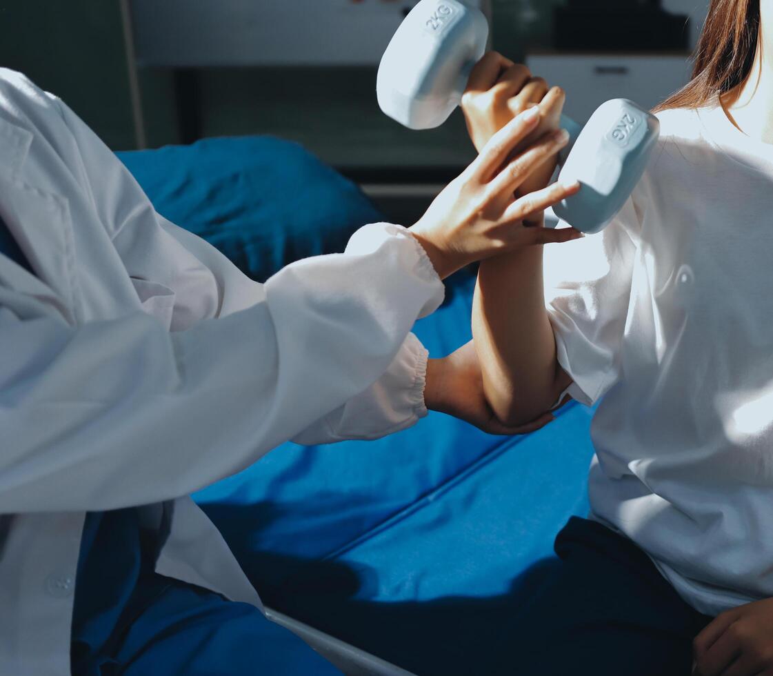 A woman is sitting on a bed with a doctor holding her arm photo