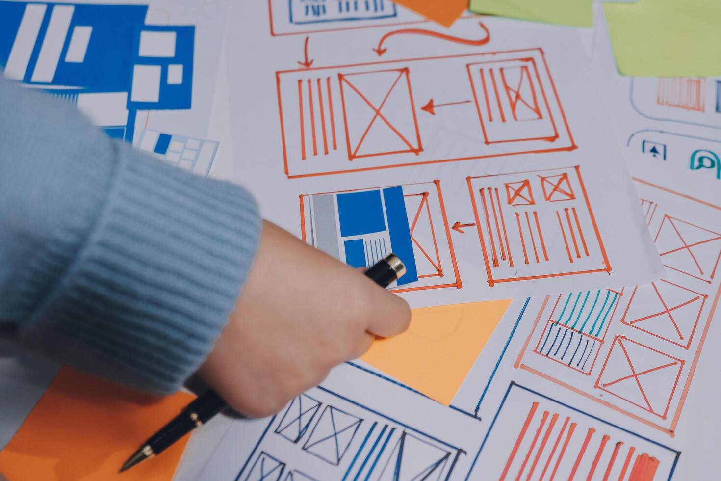 A person is drawing on paper with a pen photo