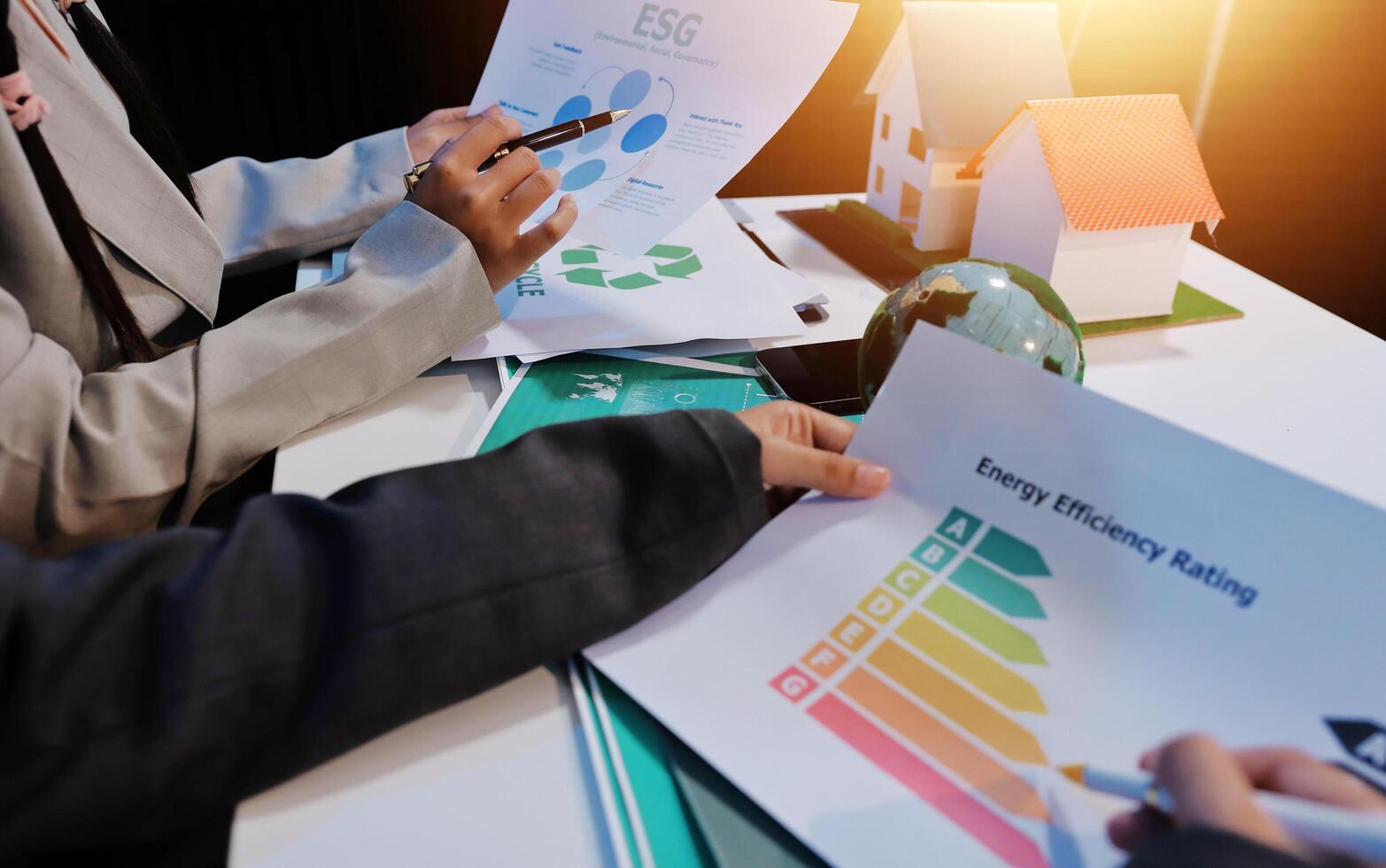 Business people working on energy efficiency report photo