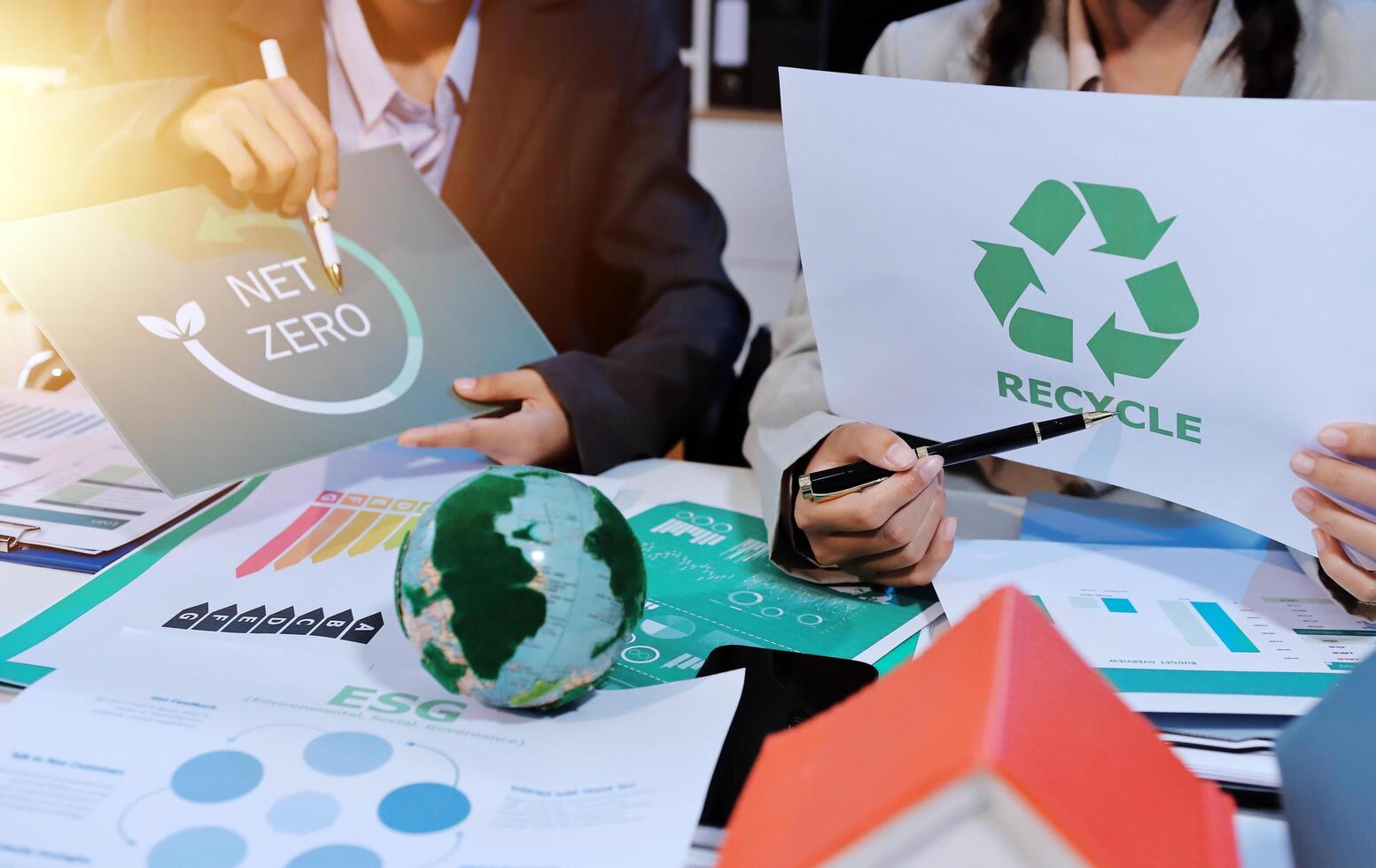 A group of people are holding paper with the words recycle and green photo