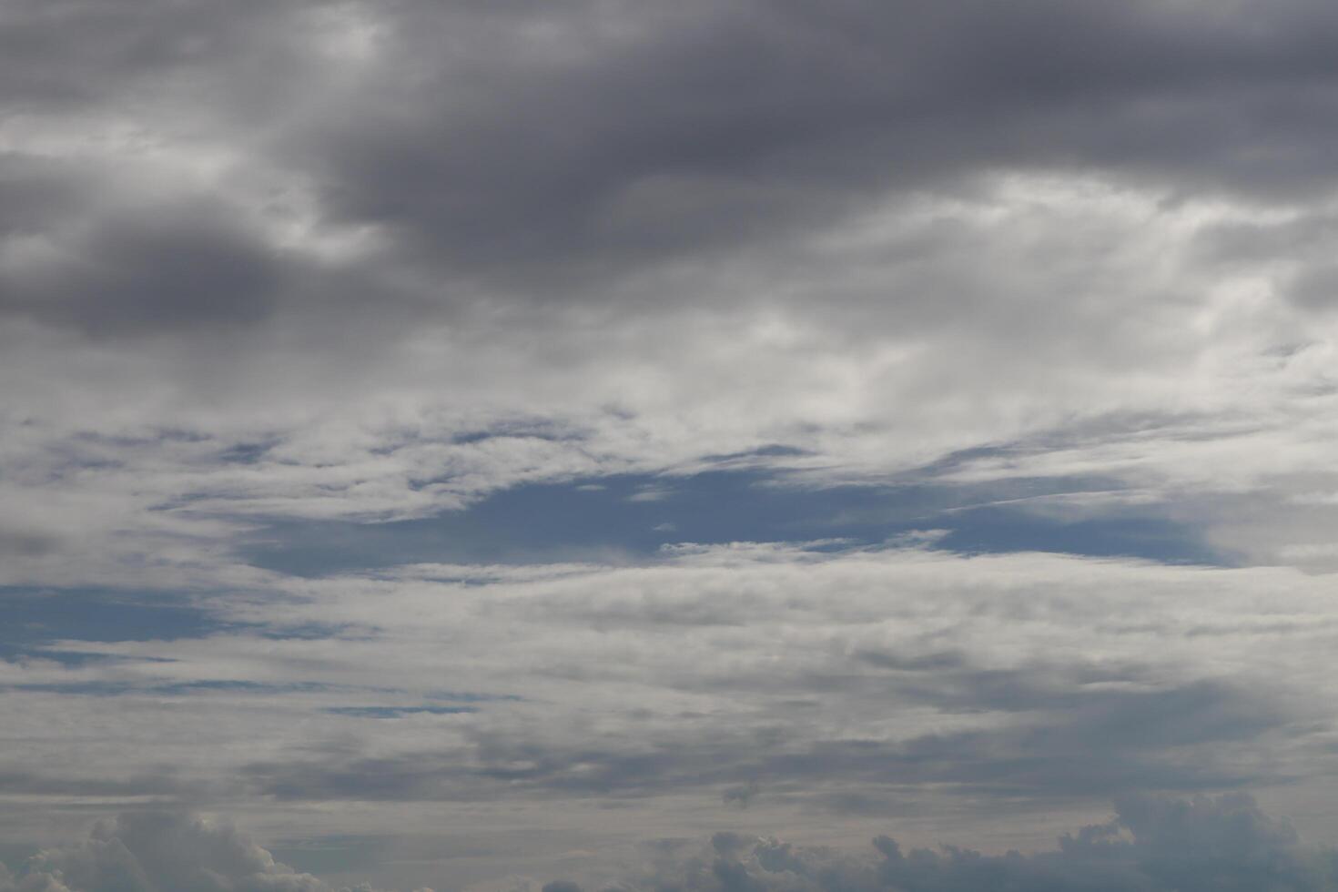 A plane flying in the sky with a cloudy sky photo
