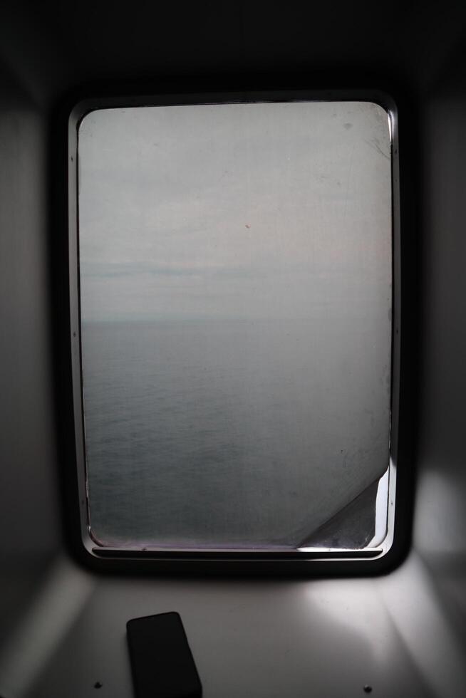 A square window in a dark room photo