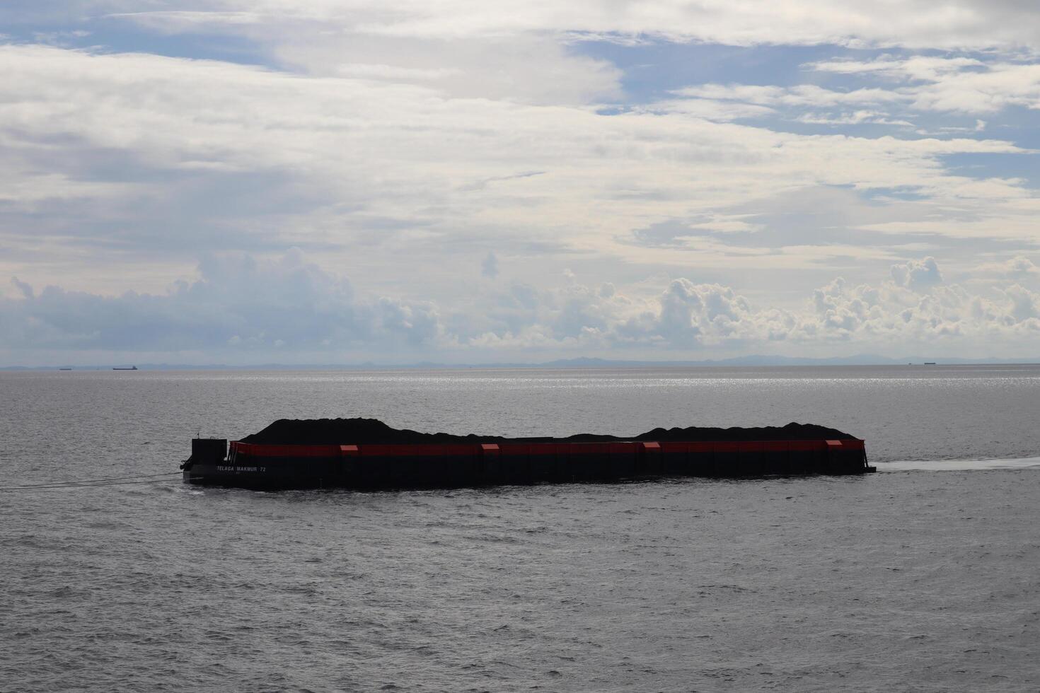 A large boat floating in the ocean with a red line photo