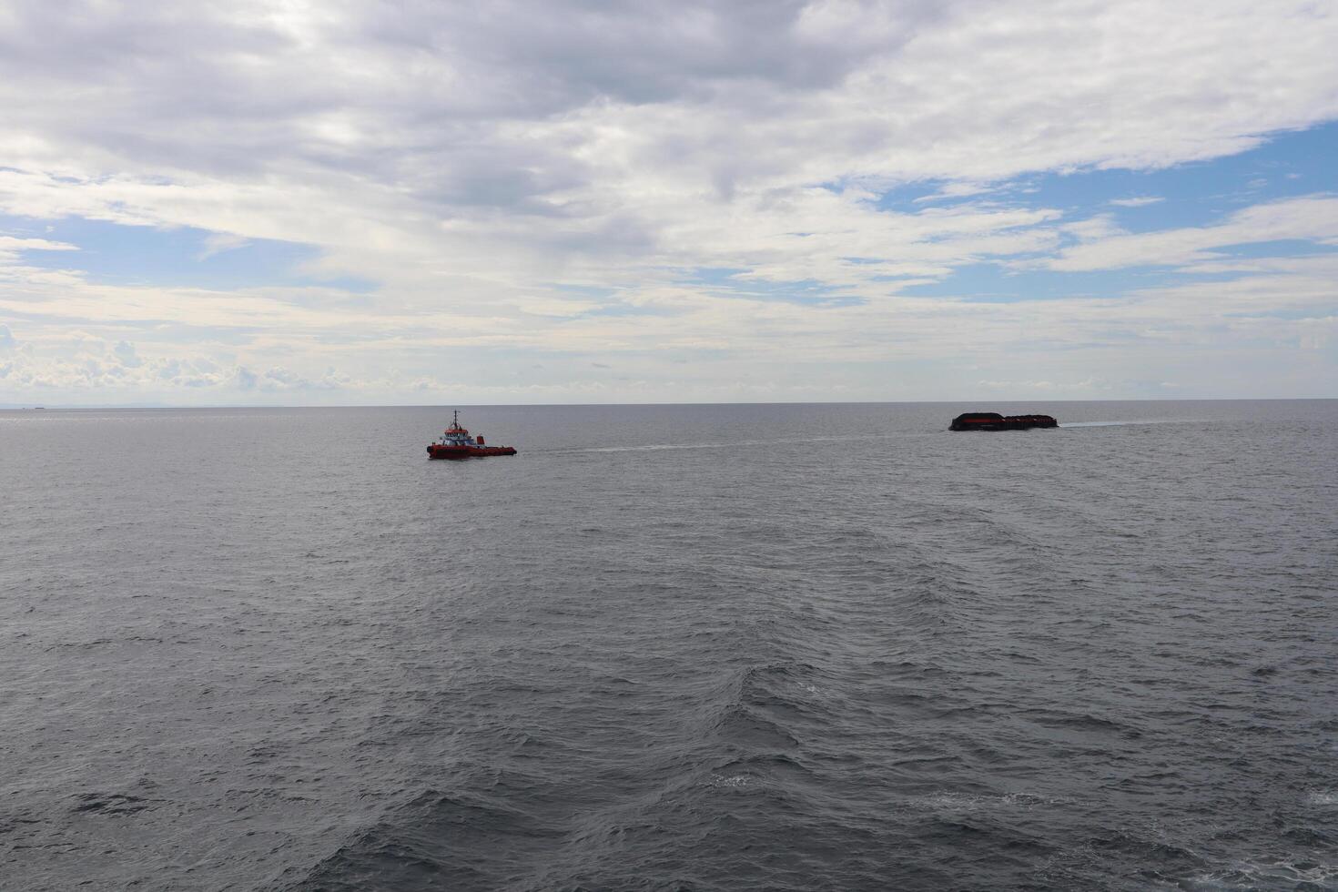 A boat is in the middle of the ocean photo