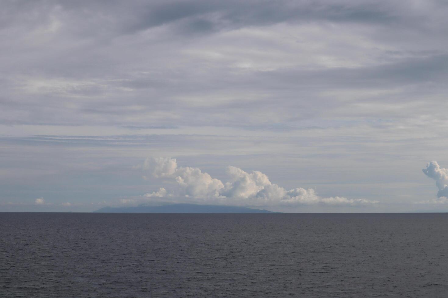 A large body of water with a plane flying over it photo