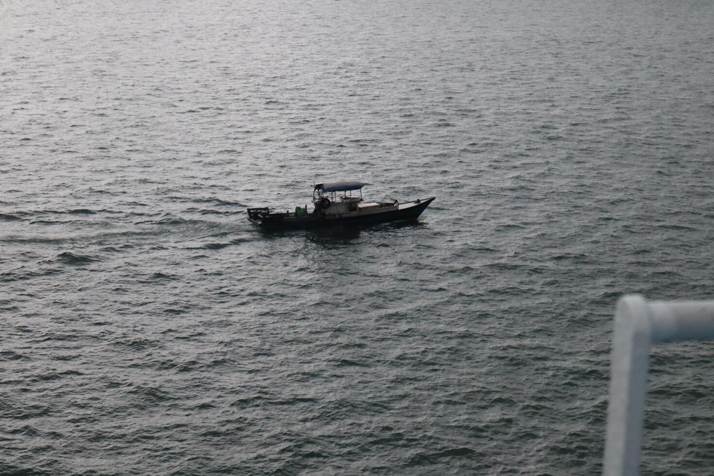 A small boat is floating in the water photo