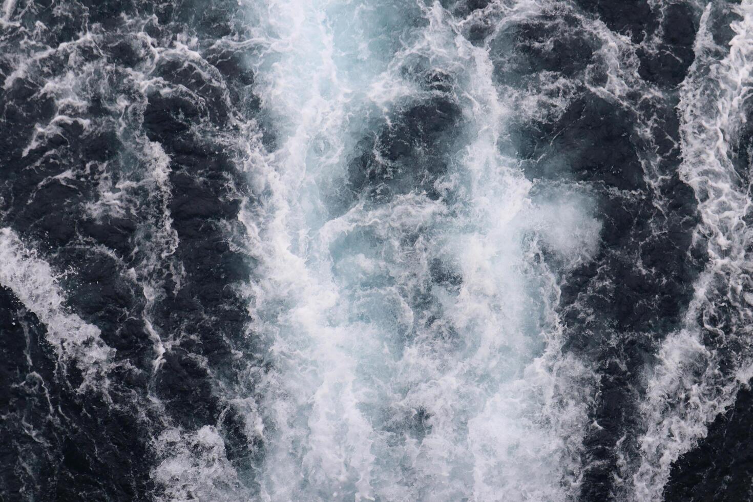 A large wave is crashing into the ocean photo