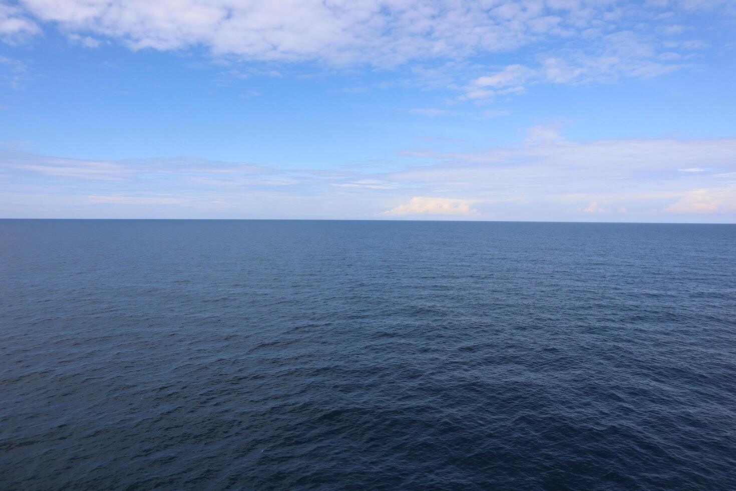 A large body of water with a small boat photo