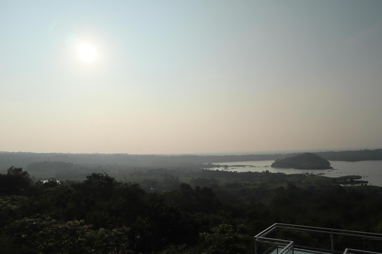 A view of a lake and a city from a hill photo
