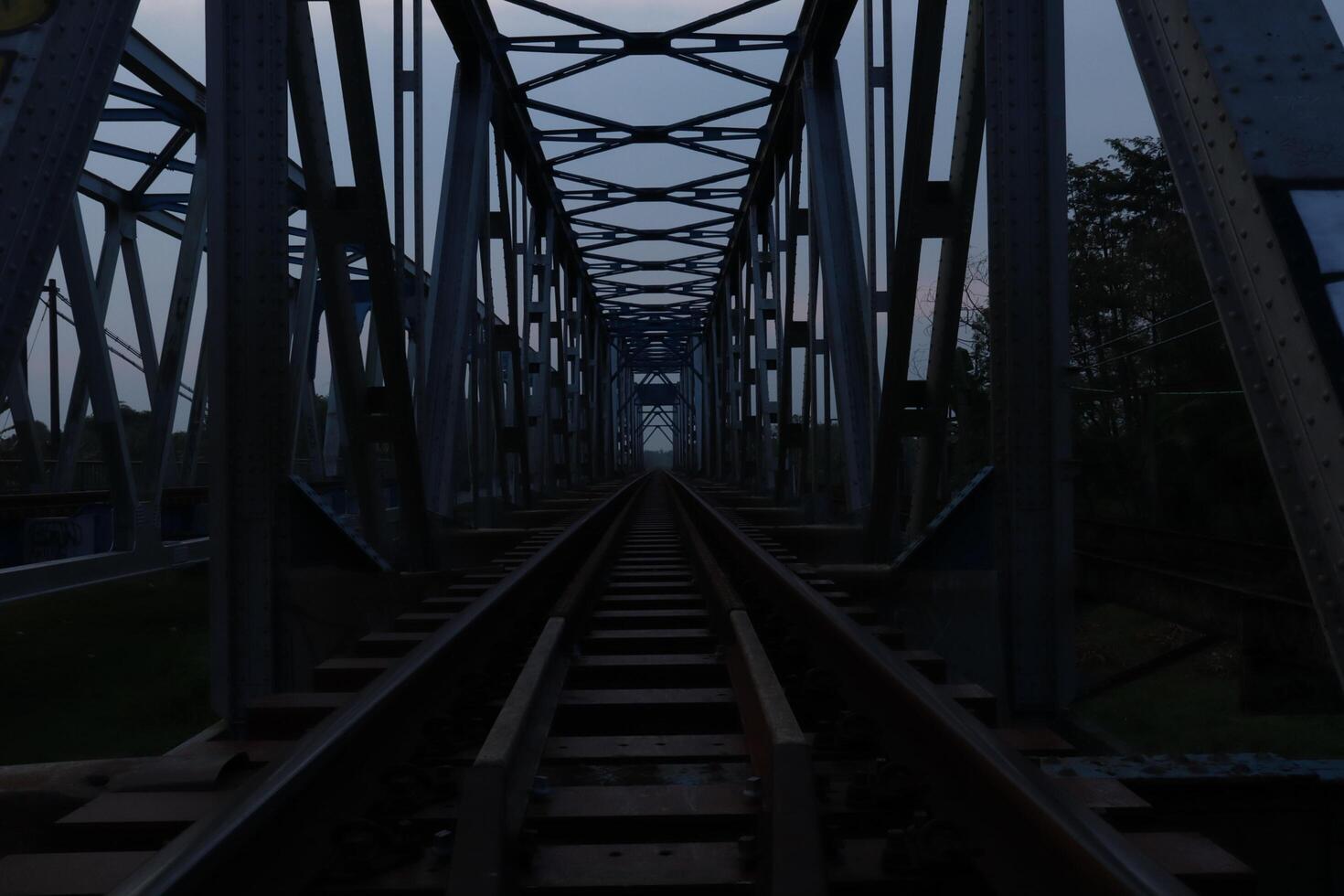 A train track on a bridge at dusk photo