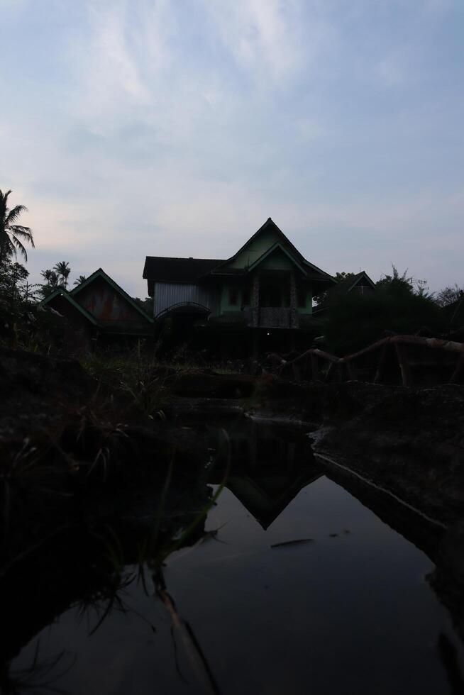A house in the distance with a reflection of the sky photo