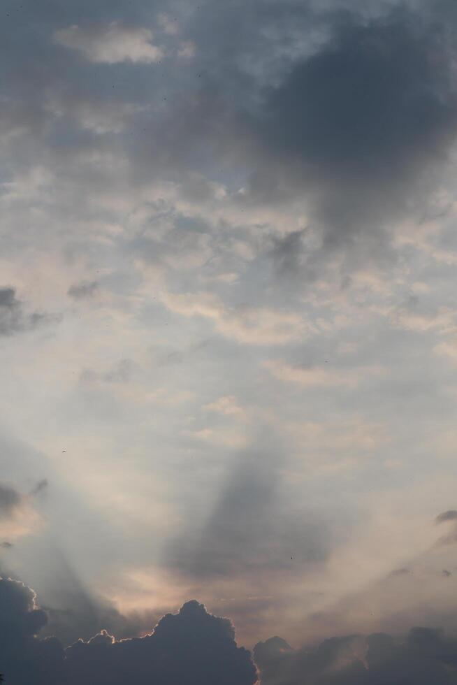 A plane flying through the sky with clouds photo