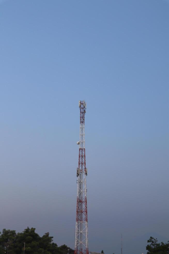A tower with a red and white antenna photo
