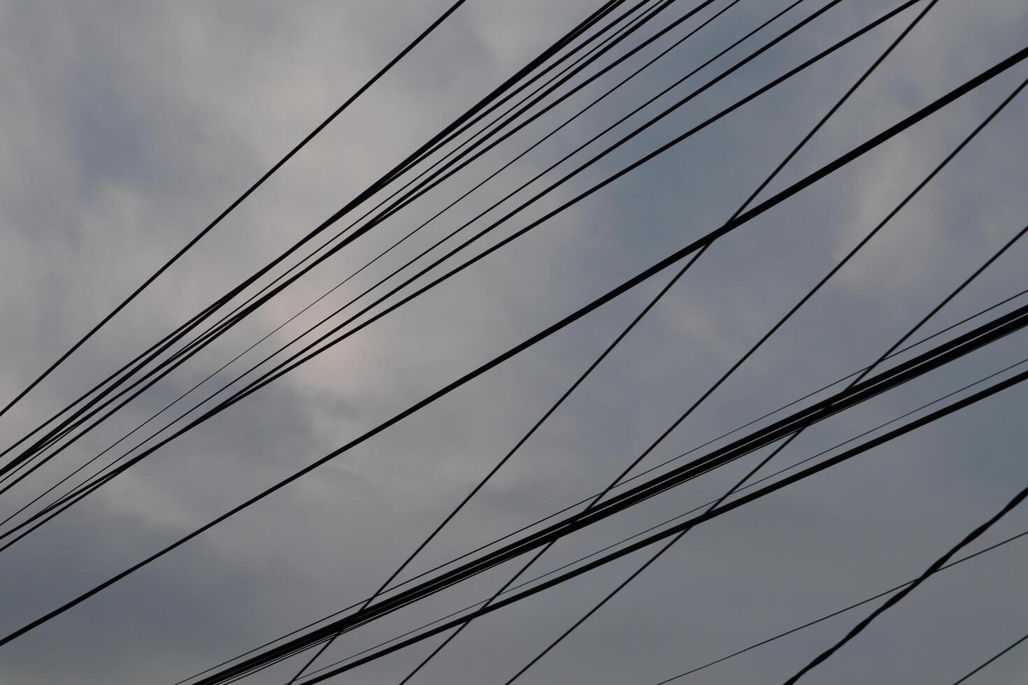 A view of the sky with many wires photo