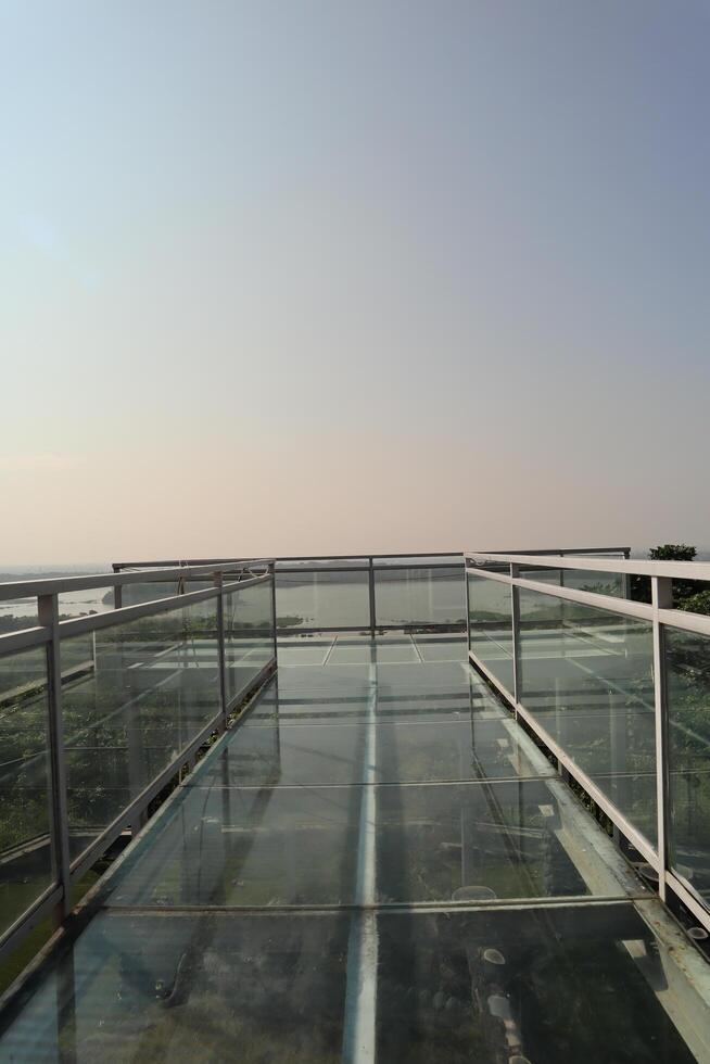 A view of a building from the top of a glass walkway photo