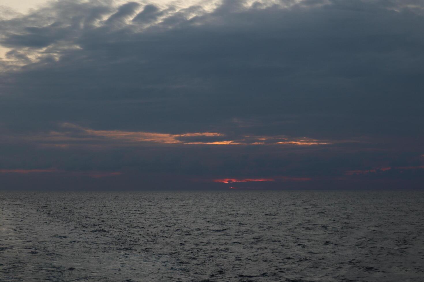 A boat on the ocean with a sunset in the background photo