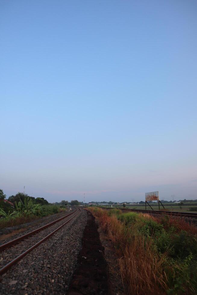 A train traveling down a track with a sign on it photo