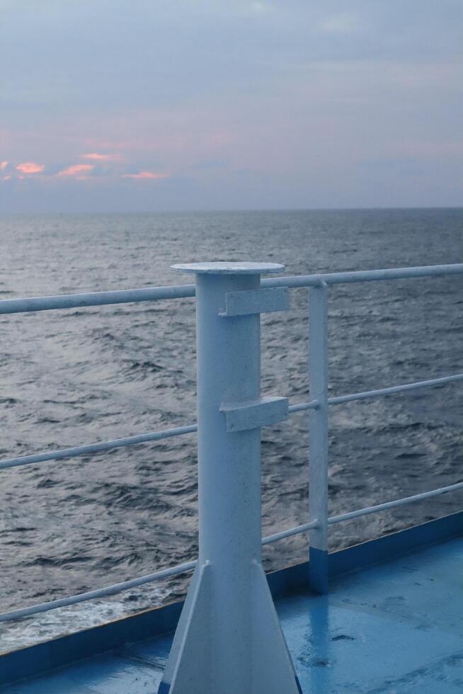 The view from the deck of a ship at sunset photo