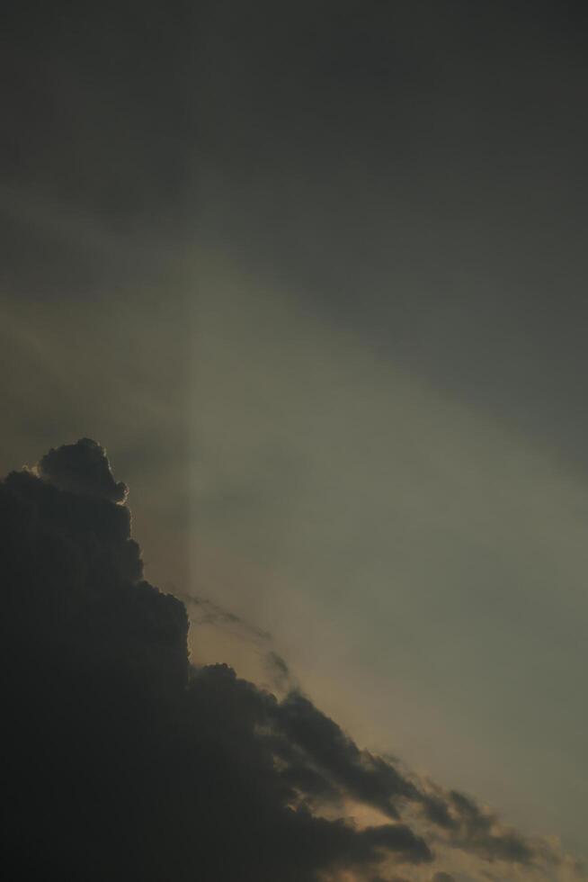 A plane flying through the sky with a cloud in the background photo