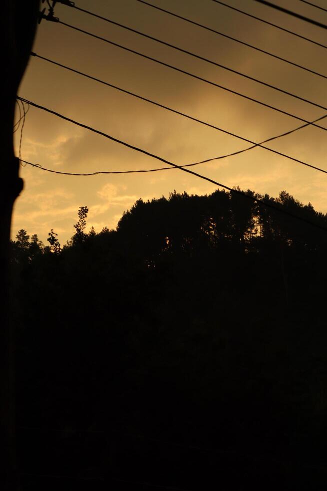A sunset view from the window of a train photo