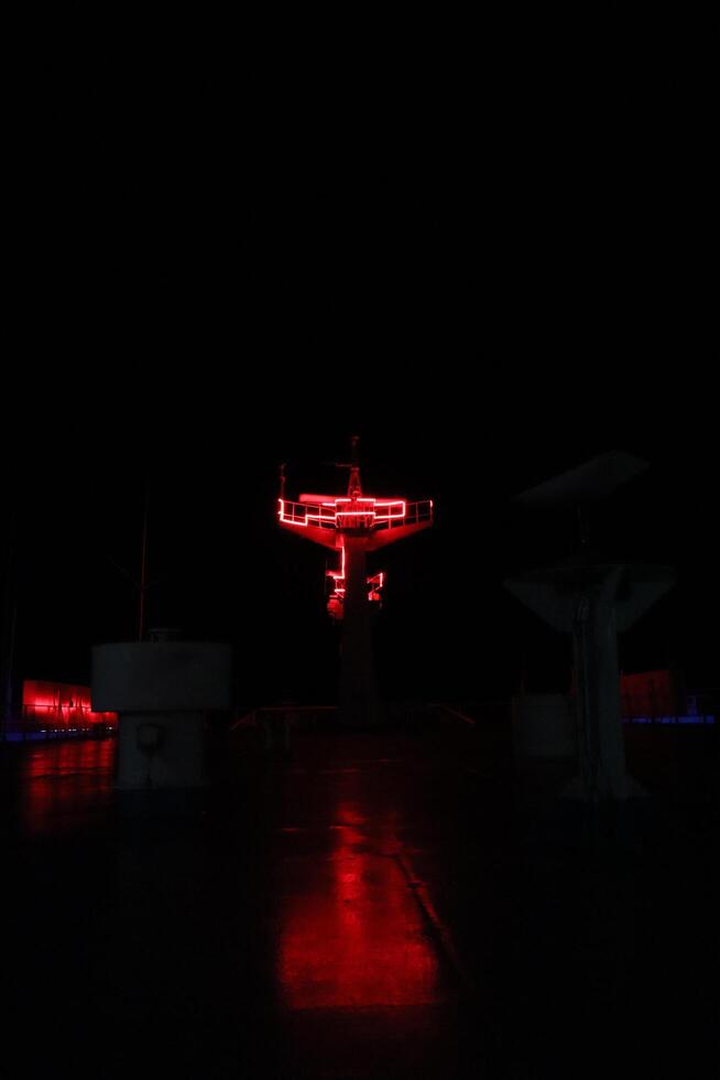 A red neon sign on a dark night photo