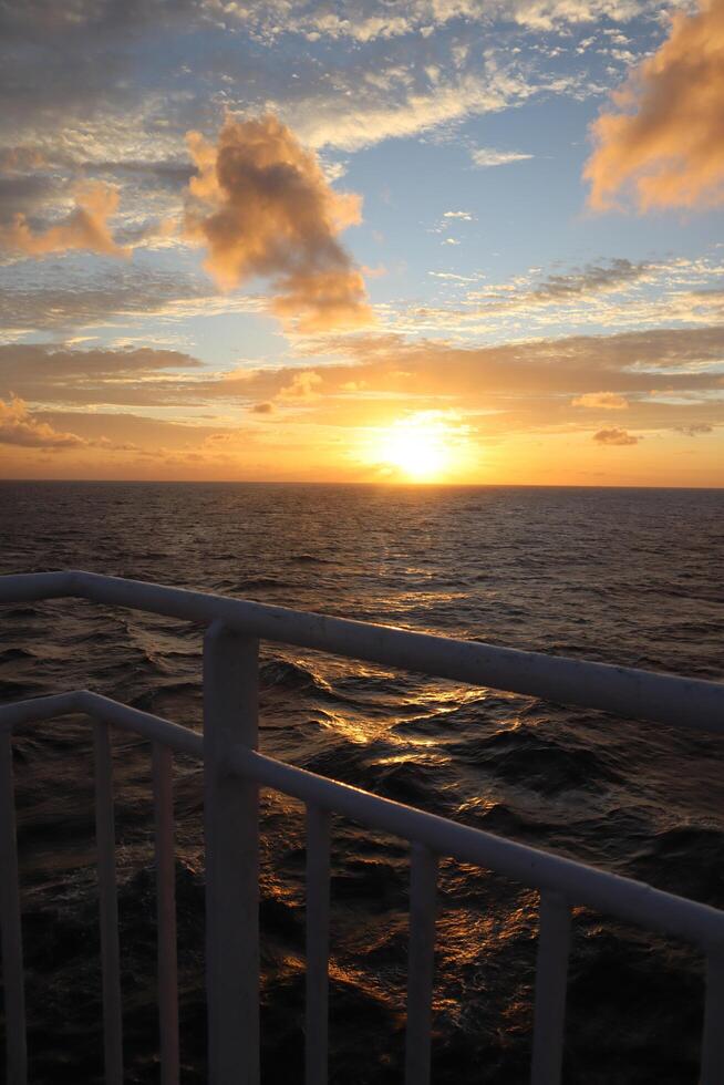 Sunset on the ocean from a cruise ship photo