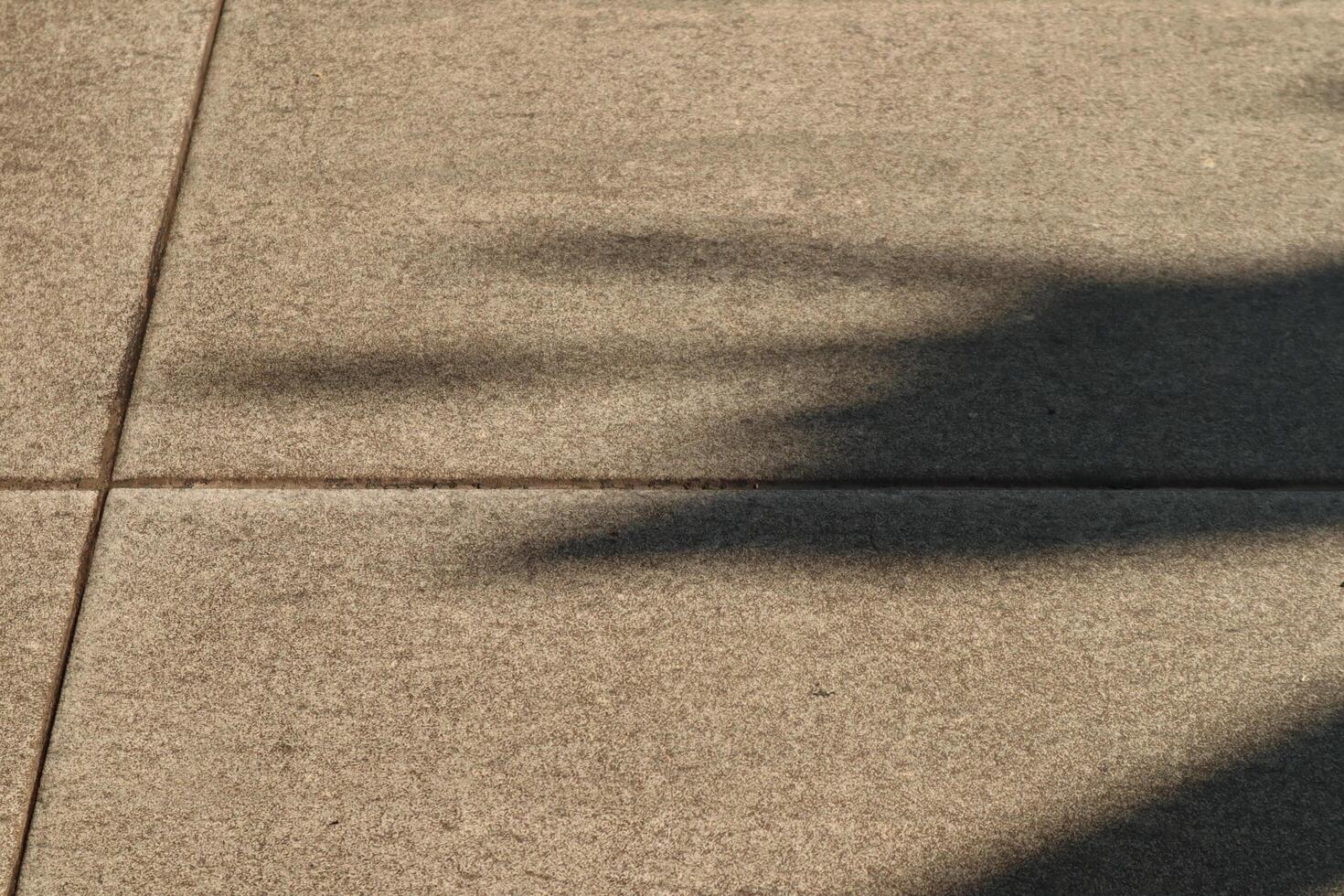 A shadow of a person on a sidewalk photo