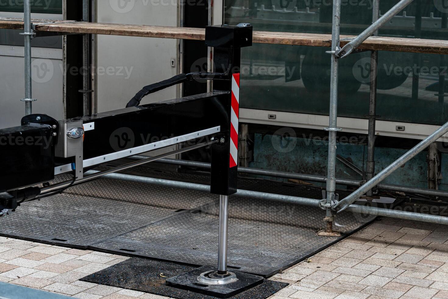 Construction equipment is positioned on a city street, surrounded by photo