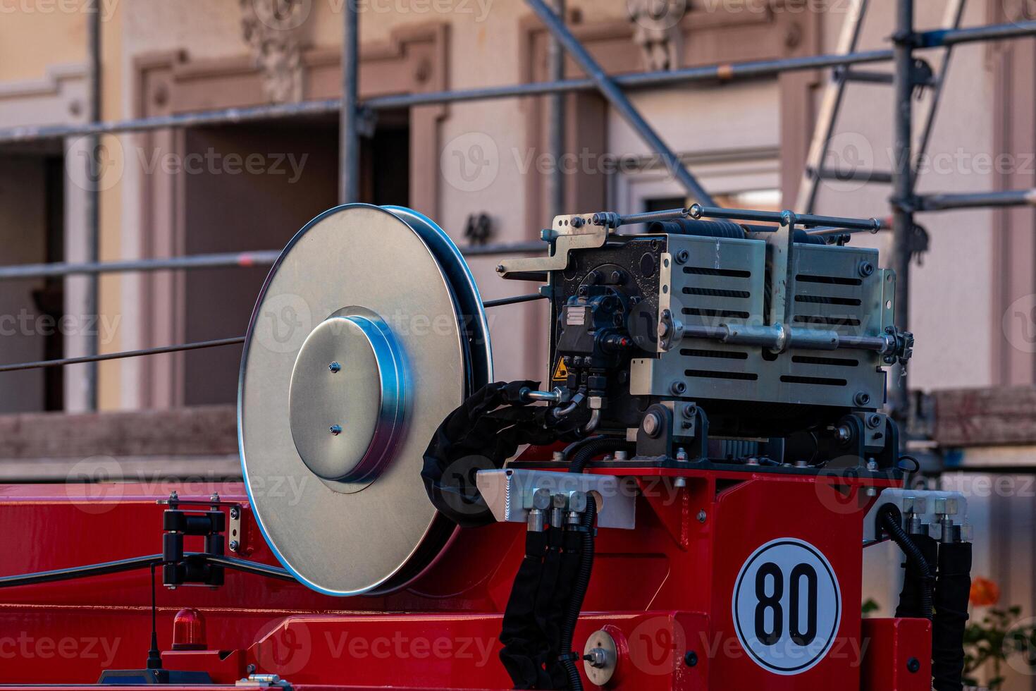 A construction rig is set up at a building site, featuring a large photo