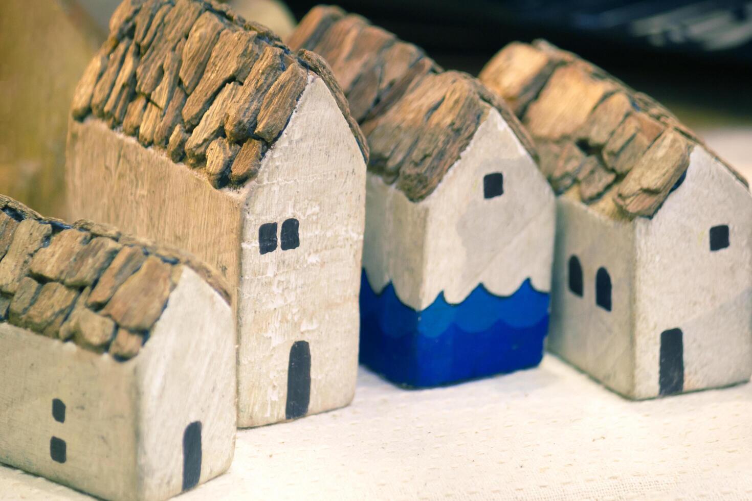 Miniature House On Top Table, Building Blocks Arranged In Row. photo