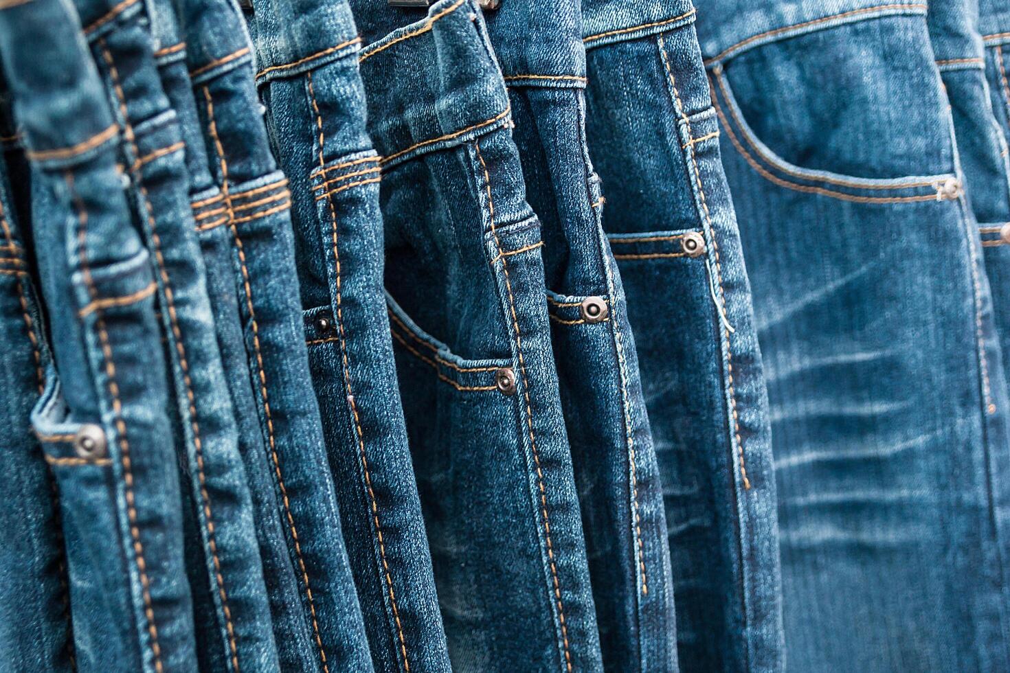 Lot of different blue jeans. photo