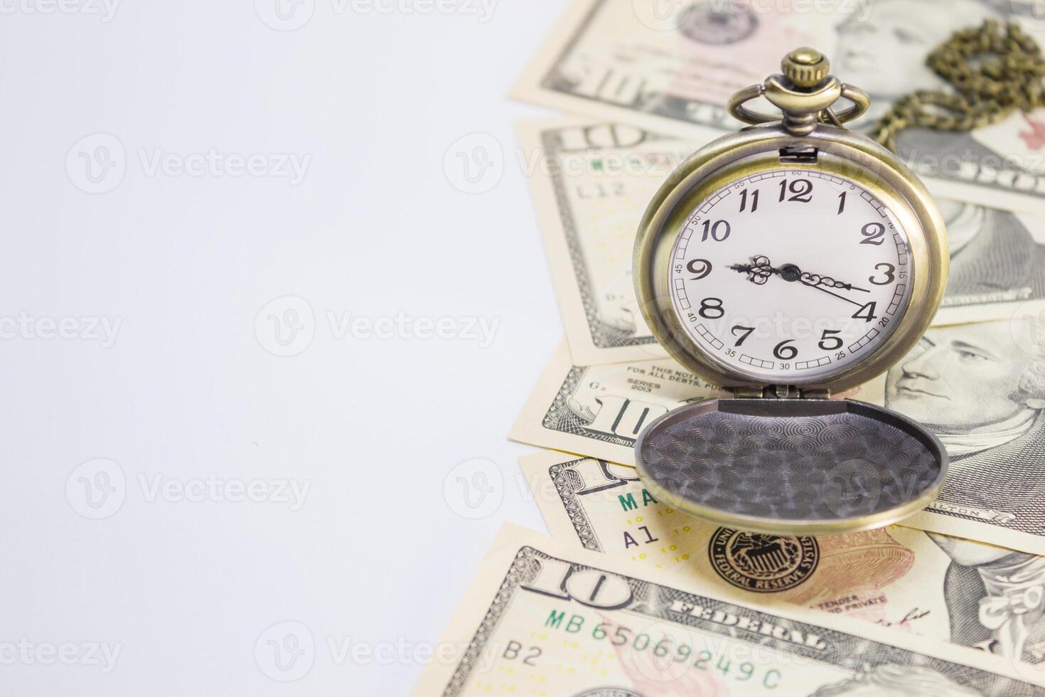 Classic pocket watch on dollar banknote, concept and idea of time value and money, business and finance concepts photo