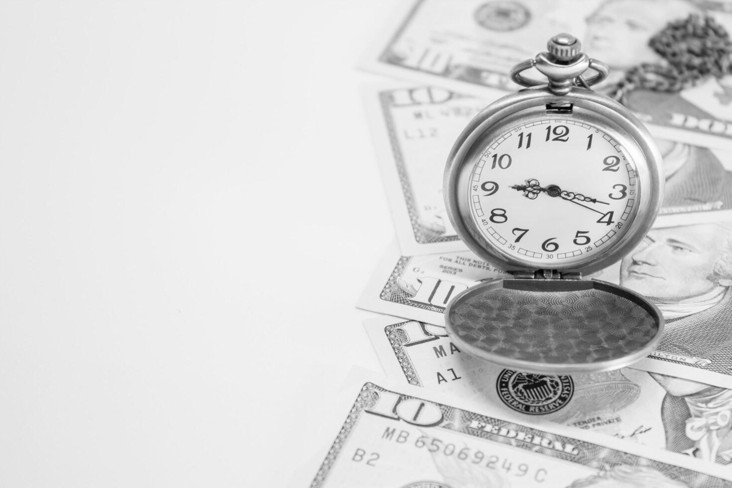 Classic pocket watch on dollar banknote, concept and idea of time value and money business and finance concepts photo