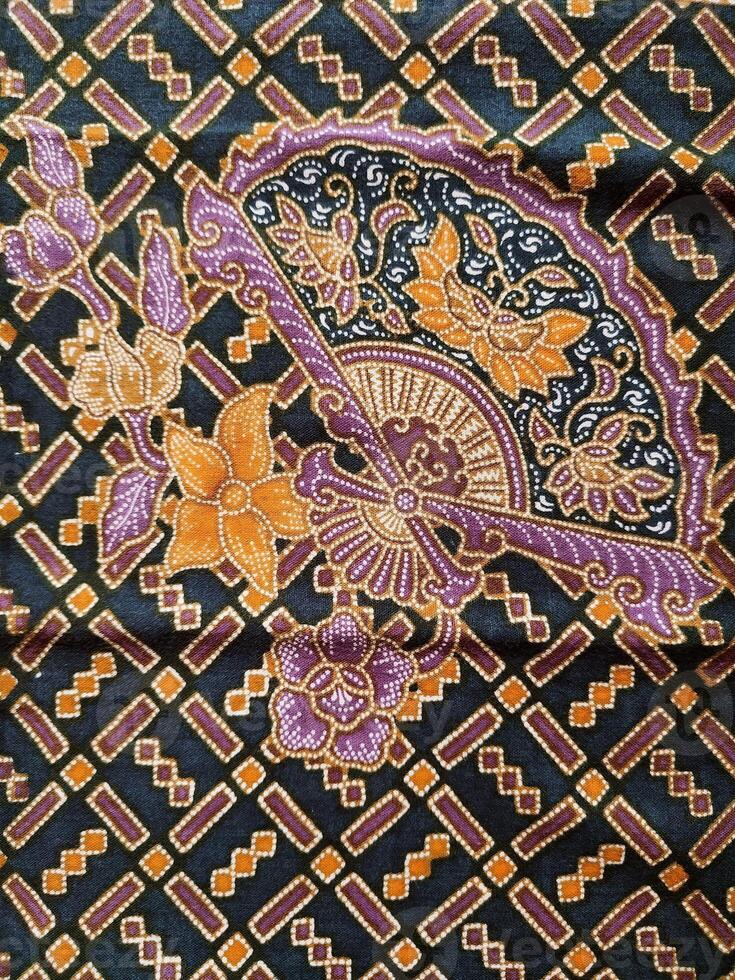 a black and purple fabric with a flower design photo