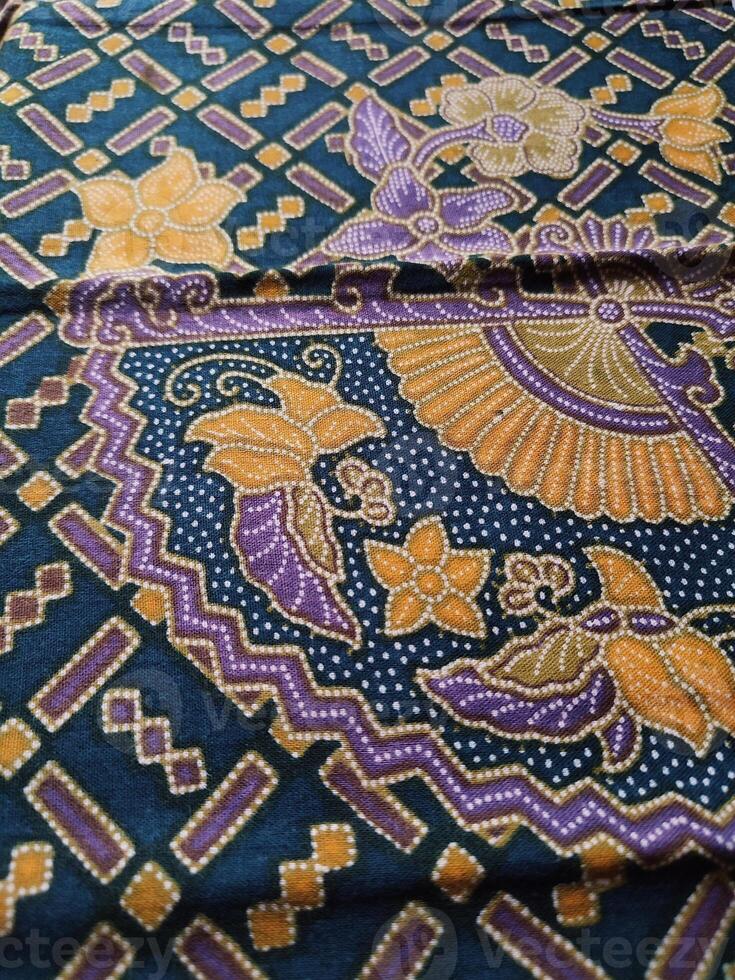 a purple and gold patterned fabric with a blue and yellow design photo