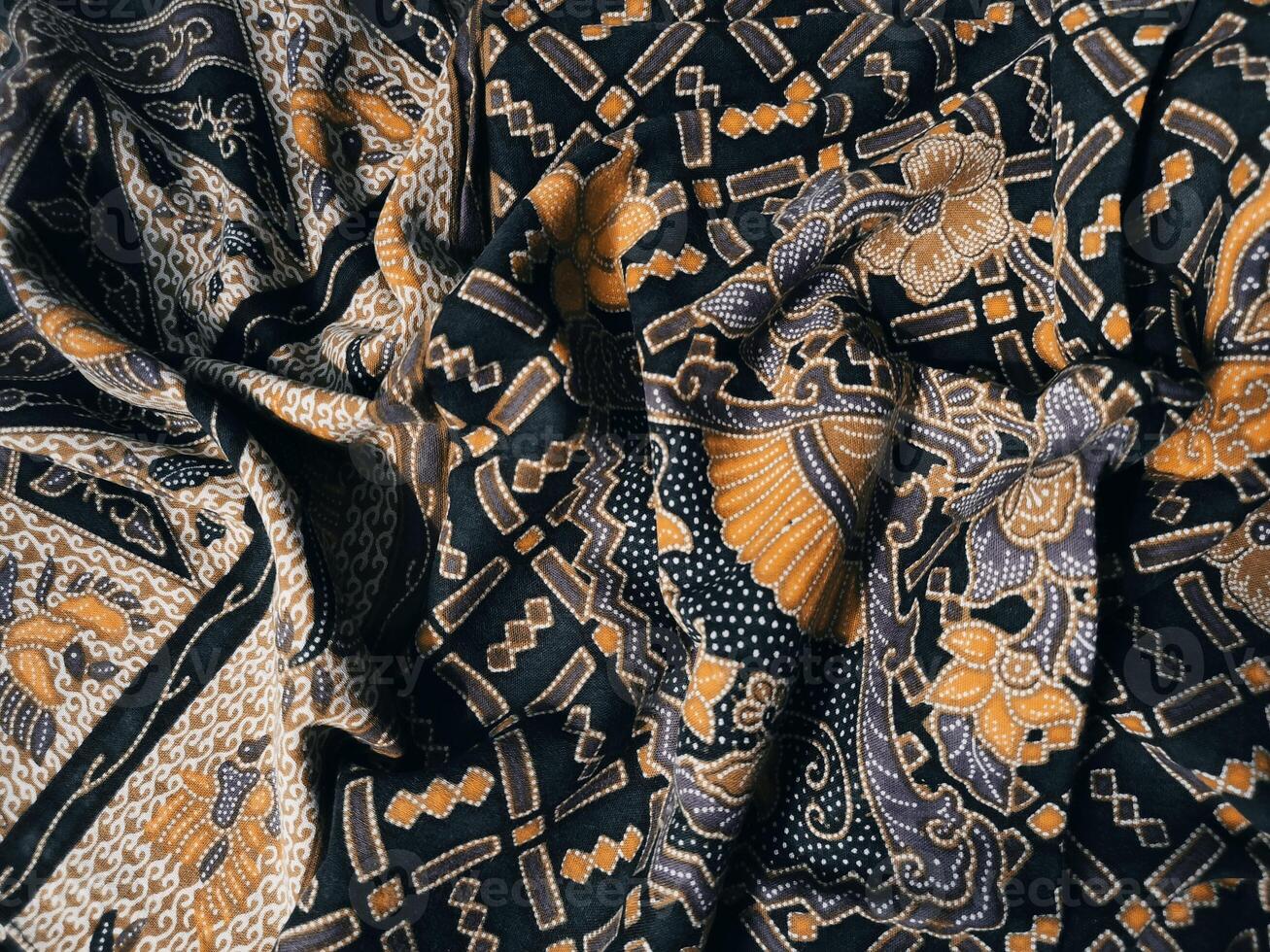 a black and yellow fabric with a pattern photo