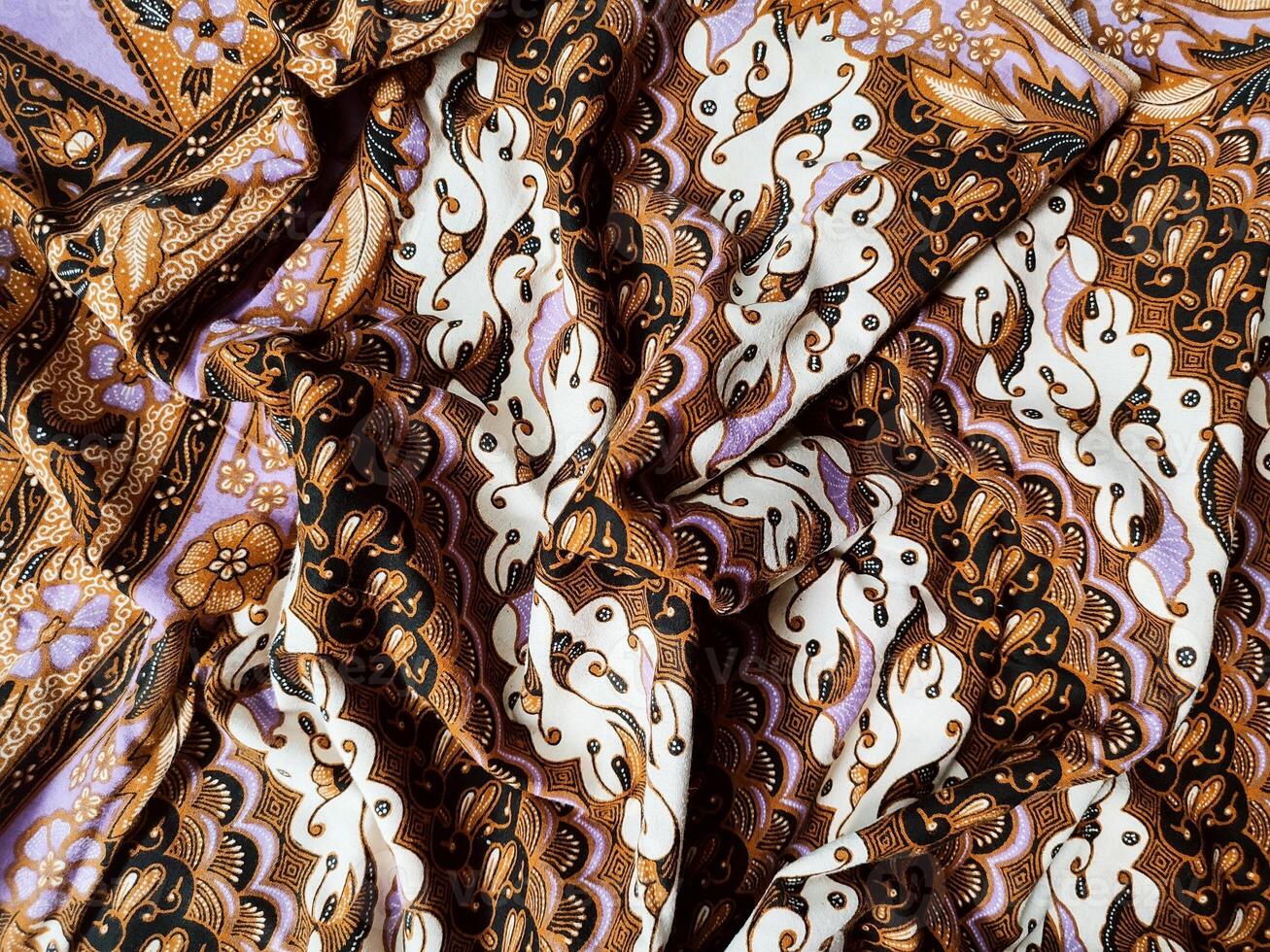 a close up of a purple and white paisley print fabric photo