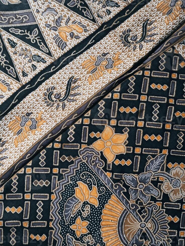 a close up of a black and yellow patterned fabric photo