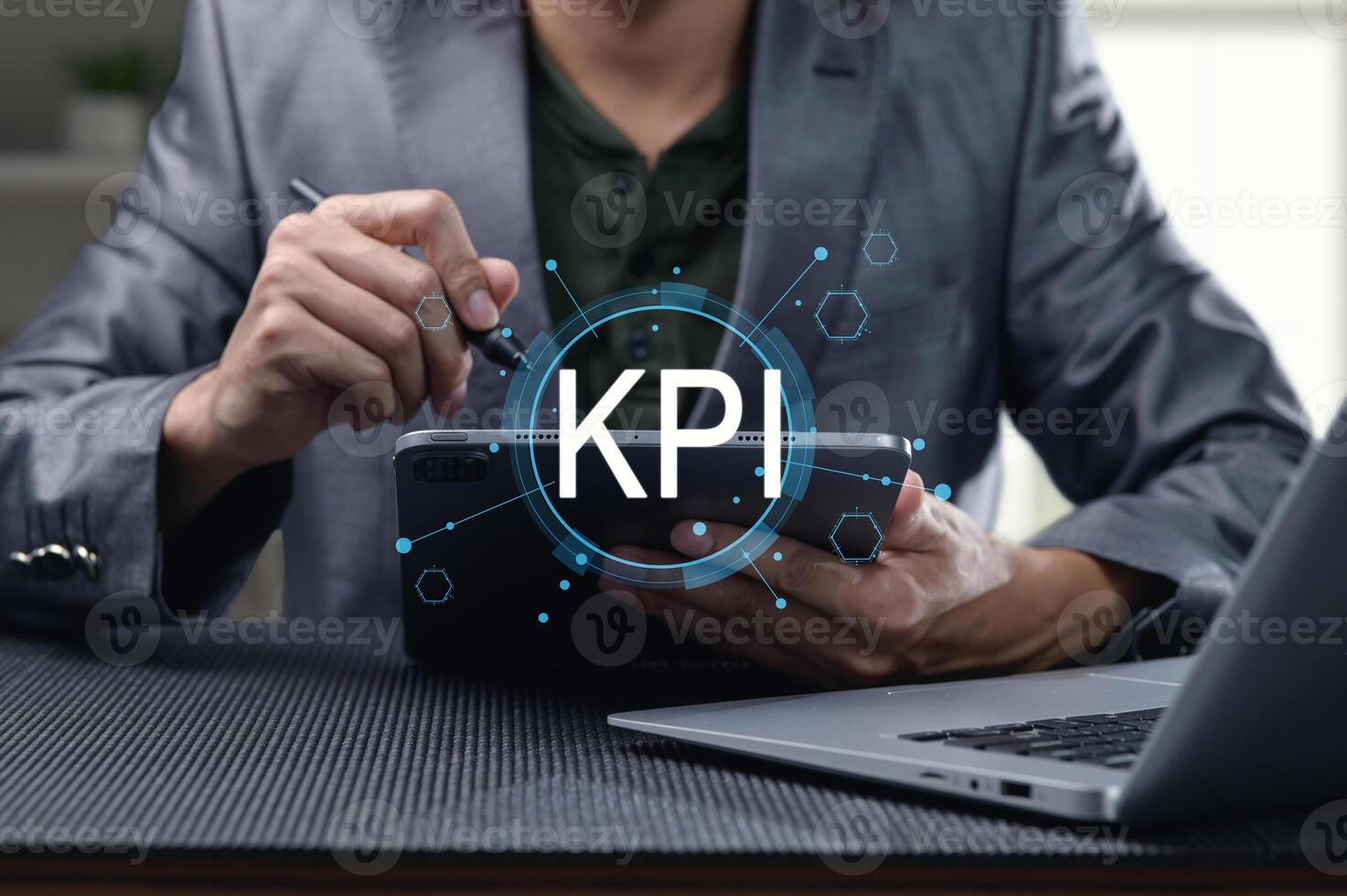 Businessman Analyzing Key Performance Indicators on Digital Device photo